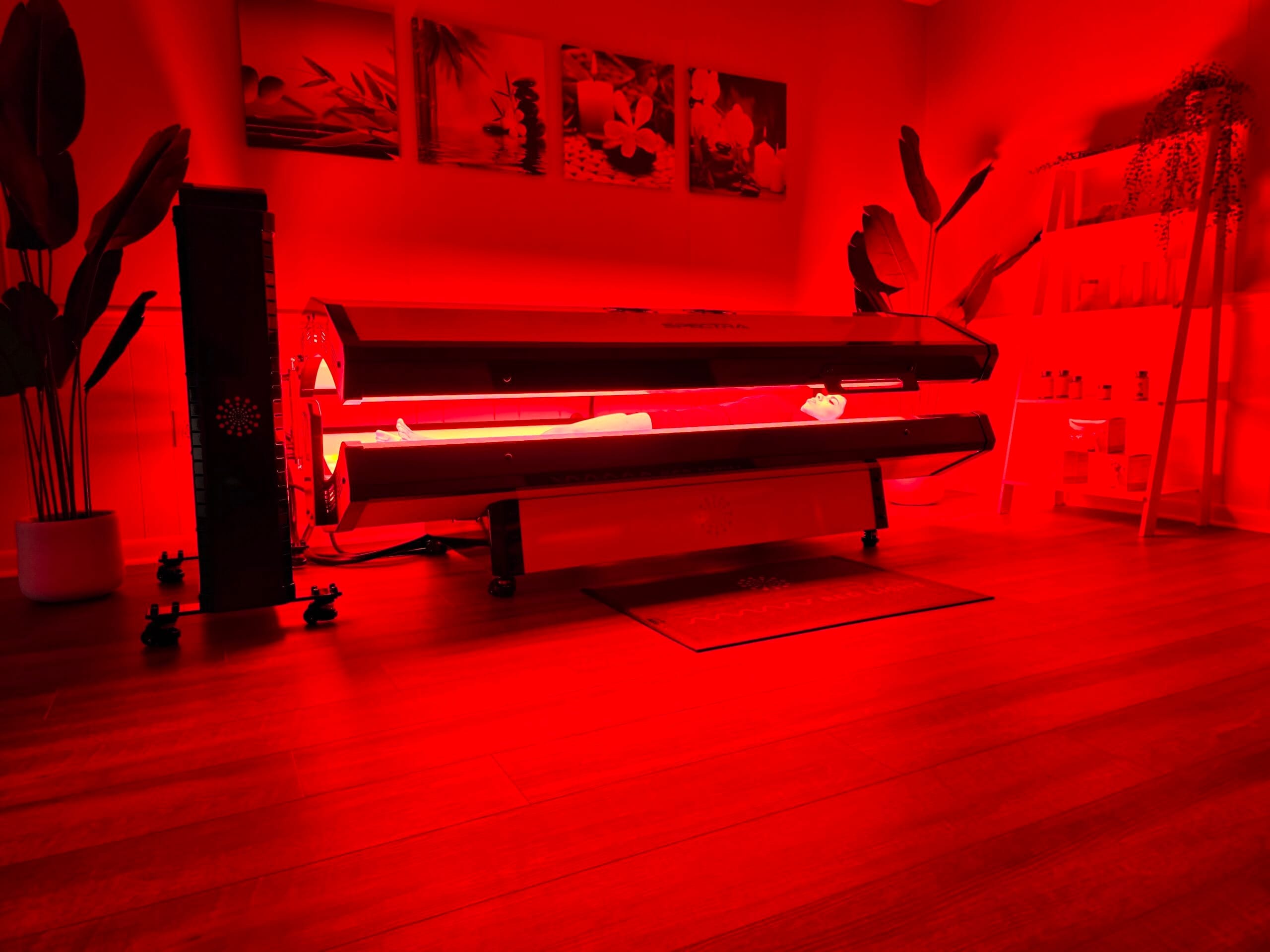 A photo of a woman using a spectra red light S10 Pro bed for a red light therapy session.